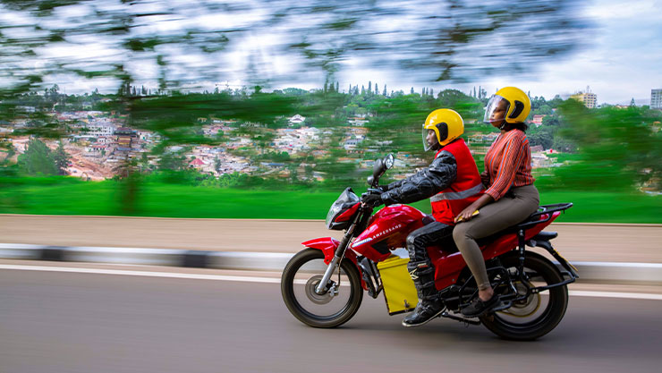 A man and woman riding in a motorbike